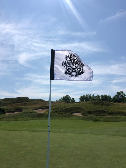 Golf flag with decorative design on a golf course