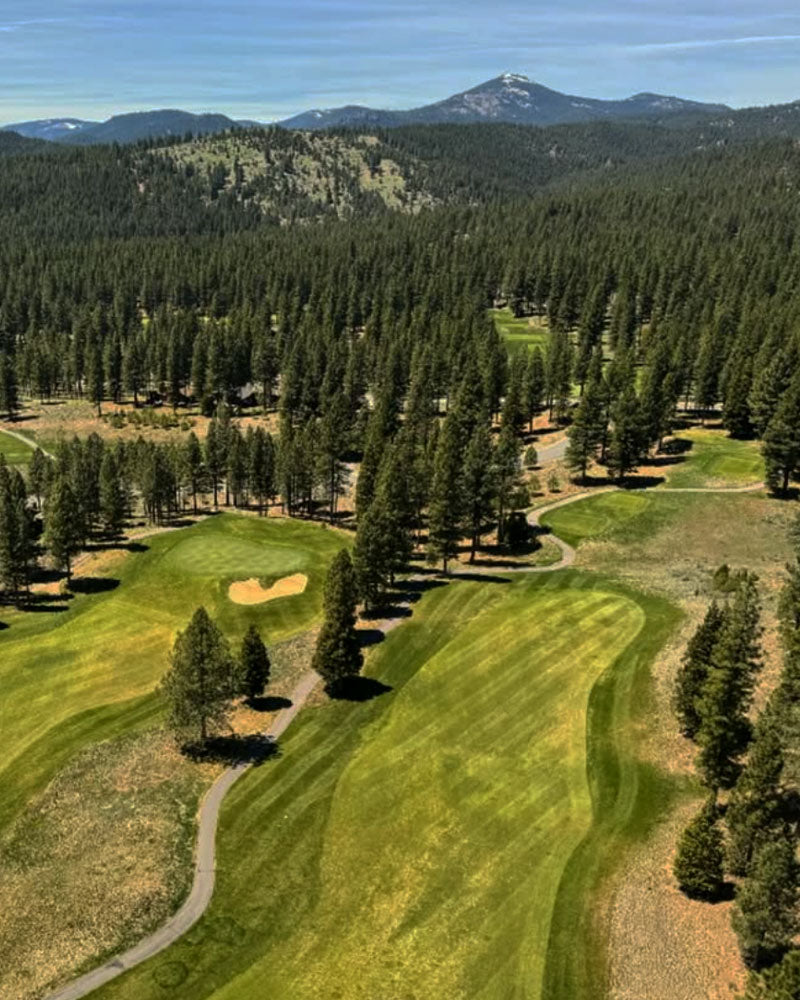 Grizzly Ranch golf course with trees and mountains in the background