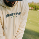 Man practicing golf in the Yardage Golf Co Sweatshirt